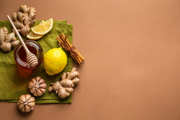 Honey glass pot, ginger, garlic, lemon to boost immune system. Natural ingredients for immunity stimulation and viruses protection. Healthy food against seasonal flu and cold, copy space background.