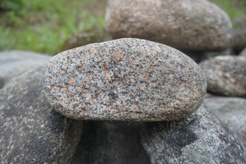 Fototapeta na wymiar plutonic granite rock on nature background. Granite, coarse- or medium-grained intrusive igneous rock that is rich in quartz and feldspar
