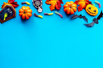 Halloween holiday background - gingerbread cookies, pumpkins and candy. Overhead