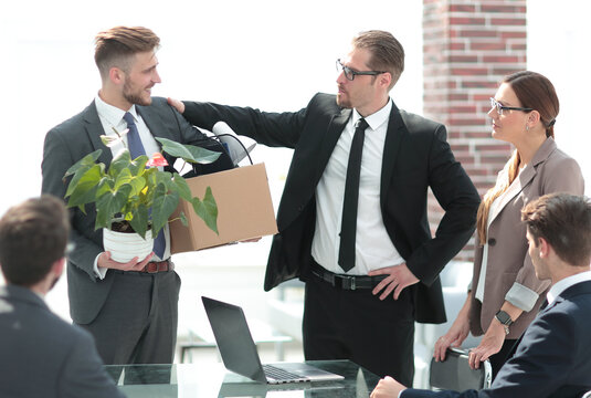 Employee With Personal Belongings Leaving The Office