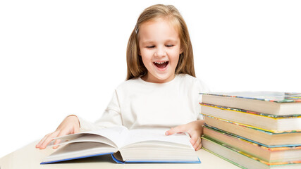 little cheerful girl sitting at the table and reads a books laughs on a white background.