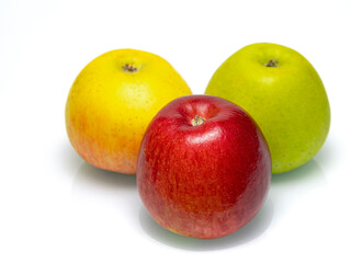 Three juicy ripe apples on a white background, close-up view.