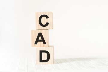 word CAD on wooden blocks, white background, business concept. business and Finance