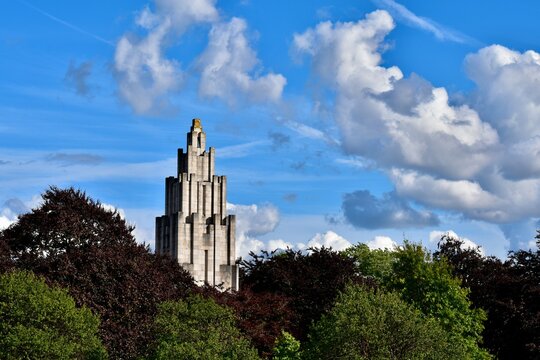 Landscape with War Memorial among trees against blue sky with picturesque clouds, Coventry, England, UK