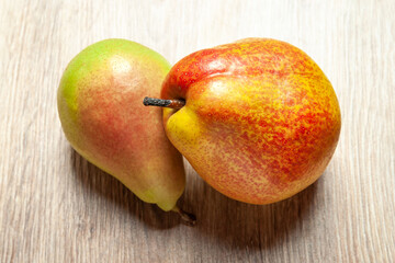 Close-up of two juicy pears. Two fresh ripe organic pears on a wooden background. Vegetarian, vegan healthy food. Diet organic product. Selective soft focus.