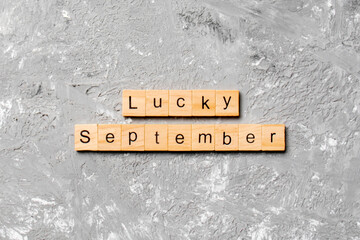 lucky september word written on wood block. lucky september text on table, concept