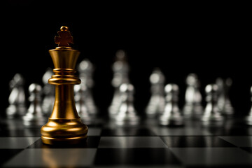 Golden King chess standing in front of other chess, Concept of a leader must have courage and...