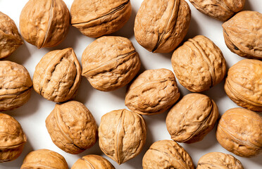 Walnuts on a white background top view. Soft focus. Stylish food background with nuts.
