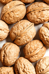 Walnuts on a white background top view. Soft focus. Stylish food background with nuts.