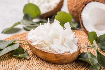 Whole and broken coconut with grated coconut flakes or chips.