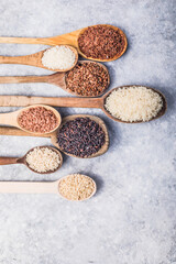 Organic white Jasmine rice, unpolished black and brown rice, Riceberry  in wooden spoons