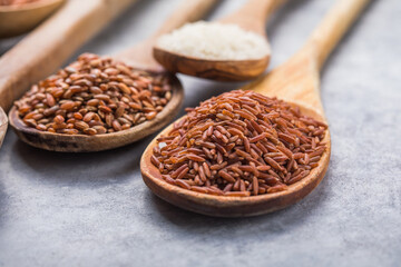 Organic white Jasmine rice, unpolished black and brown rice, Riceberry  in wooden spoons