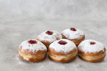Tasty donuts with jam on wooden background - Hanukkah celebration concept