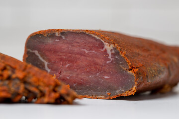 Jerky on a white background. Close-up of Armenian basturma sliced into pieces.