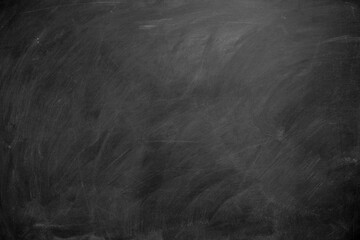 Abstract texture of chalk rubbed out on blackboard or chalkboard background. School education, dark wall backdrop or learning concept.