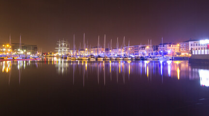 Night city Rouen in France, the pier of expensive yachts.