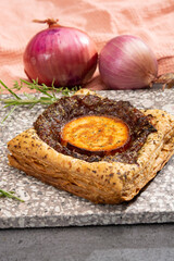 Fresh baked puff tarts with caramelized onion and goat cheese