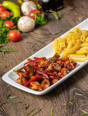 grilled cubed chicken with pasta and salad