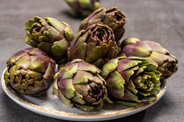 Fototapeta premium Fresh french petit violet artichokes heads cultivted in Brittany, France