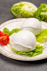 Сheese collection, balls on soft white mozzarella bufala cheese served with green cos lettuce and tomato