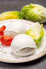 Сheese collection, balls on soft white mozzarella bufala cheese served with green cos lettuce and tomato