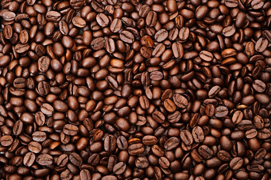 Top view of brown roasted coffee beans, can be use as background, copy space for text. © tonstock