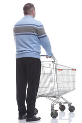 rear view. casual man with a cart standing in front of a white screen