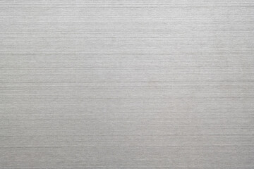 Silver metal texture of brushed stainless steel plate with the reflection of light.