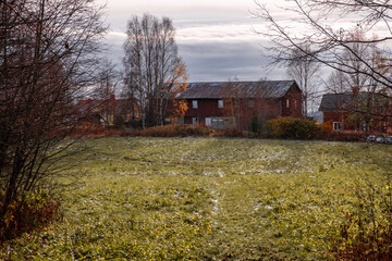 Old red barn with a grass field in autumn