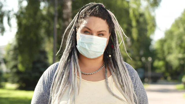 Portrait of female body possitive caucasian women or adult girl wear medical face mask greeting with camera. Health care and medical concept of coronavirus protection covid 19 spreading prevention