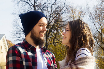 a guy and a girl look at each other and smile