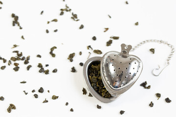 Green tea in a grid, tea in granules on a white background.