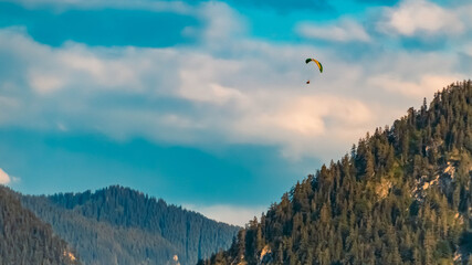 Beautiful alpine summer evening view with a paraglider at the famous Tegernsee, Bavaria, Germany