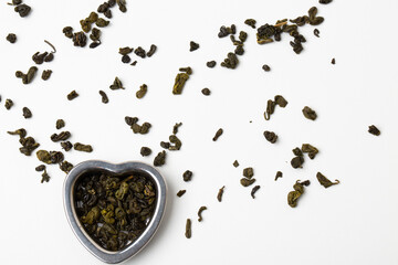 Green tea in a grid, tea in granules on a white background.
