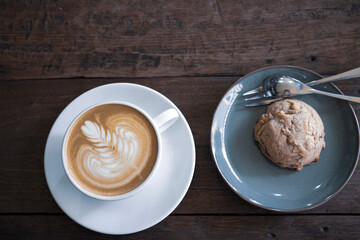 top view of coffee break showing beautiful latte art and chocolate chip cookie
