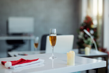 Glass of Champagne on office table during Christmas holidays.
