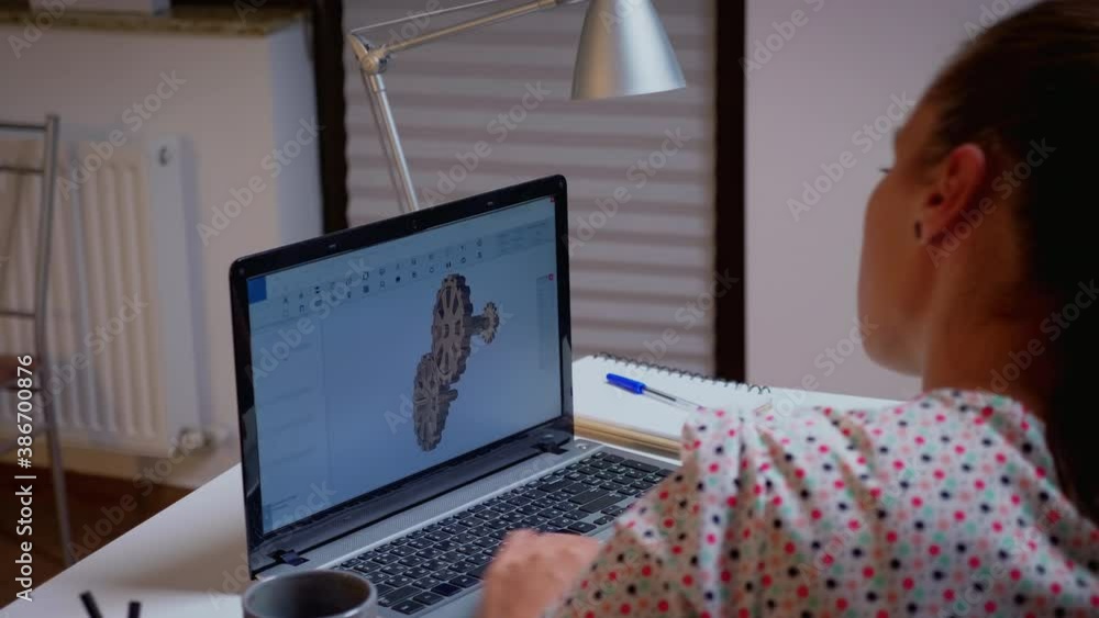 Poster freelancer working remotely on cad software using laptop innovating an efficient eco-friendly motor 