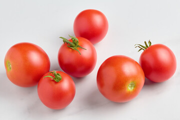 ripe organic red colored tomatoes close-up on a marble surface. flat lay, top view