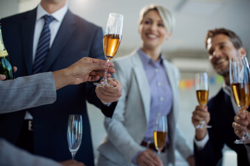 Close-up of business colleagues drinking Champagne on a party in the office.