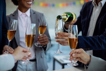 Close-up of business team drinking Champagne on office party.