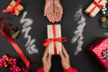 Giving a present to another person.Christmas and New Year atmosphere