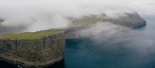Fototapeta na wymiar Aerial view of Trælanípan cliff and lake Leitisvatn, Vágar Faroe Islands.