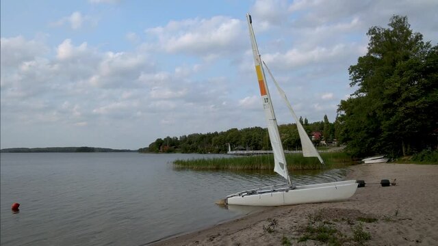 Catamaran on a shore of Narie lake in Kretowiny village in Ilawa Lake District, Warmia Mazury region of Poland
