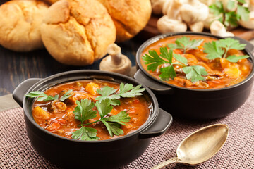 Stew soup with meat, potatoes, mushrooms and red pepper