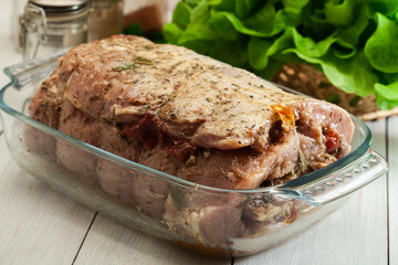 Marinated raw pork roll ready to roast