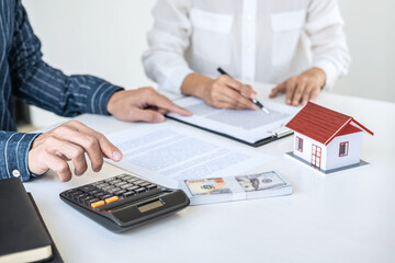 Real estate broker agent being analysis and making the decision a home estate loan to customer, Agent man is using calculator to presentation detail and waiting for his reply to finish