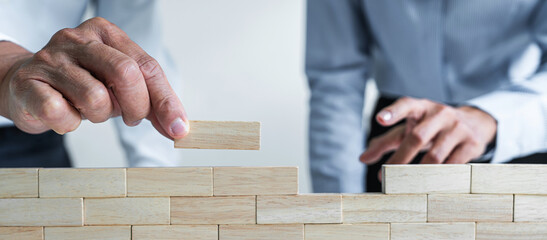 Plan and strategy in business, Risk To Make Business Growth Concept With Wooden Blocks, hand of man...