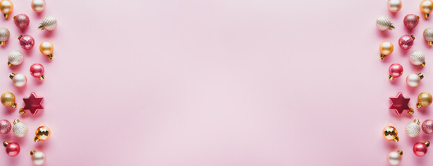 A lot of Christmas balls of pink and gold color.