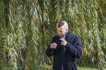 A man takes off his mask in the local park