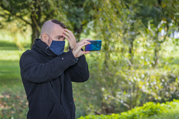 A man take a selfie in a local park